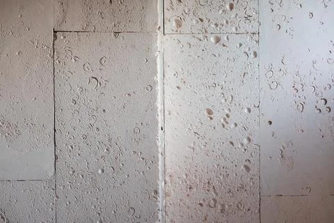 Textured wall lined with shell rock tiles. Stock Photos