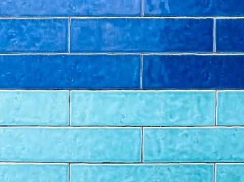 A textured wall showcases two distinct horizontal rows of rectangular tiles Stock Photos