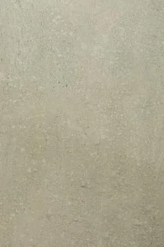 Textured wall surface with subtle patterns and earthy tones in a well-lit Stockfoto's