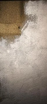 Textured wall surface with white and brown paint. 스톡 사진