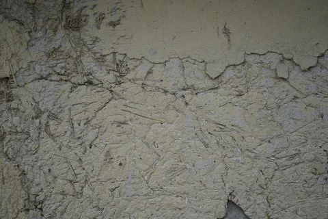 Textured weathered concrete wall surface with cracks and peeling plaster backgro Stock Photos