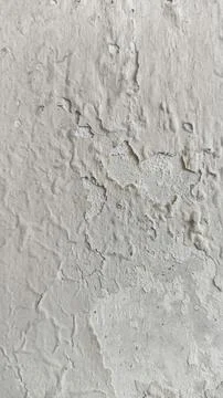 Textured weathered grey wall surface with dirt, stains, and peeling paint. .. Stock Photos