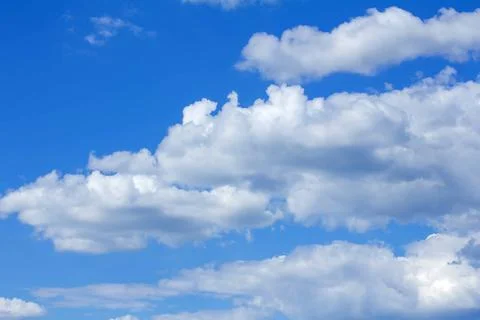 Textured white clouds on blue sky background Stock Photos