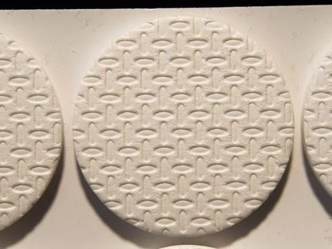 Textured White Round Tablet with Pattern Detail Stock Photos