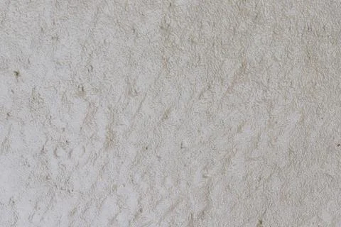 Textured Off-White Surface with Irregular Markings 库存照片