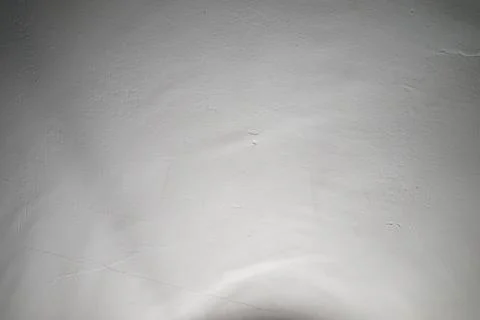 Textured white wall under soft light in a quiet indoor setting Stock Photos