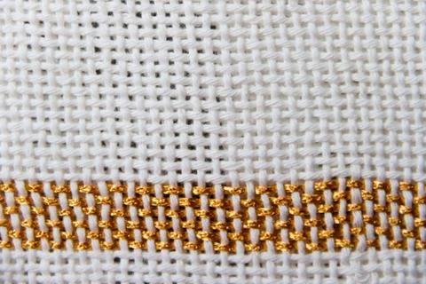 Textures of loom-woven threads in white tones with golden edges Stock Photos