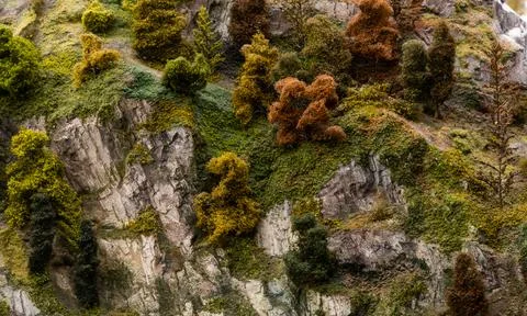 Textures of rocks, grass and trees in toy landscape. Stock Photos
