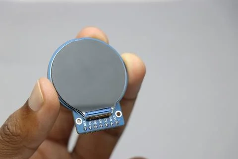 TFT LCD of round shape held in the hand. Digital LCD screen display Stock Photos