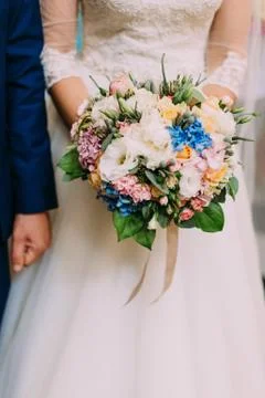 Th vertical close-up view of the wedding bouquet of white, blue and pink flowers Stock-Fotos