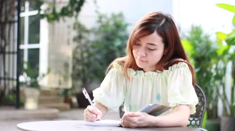 Thai adult beautiful girl write a book. Stock Footage 59604189