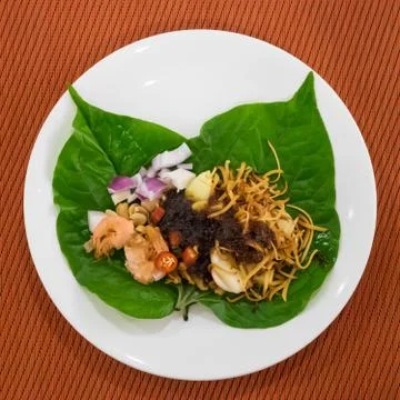 Thai appetizer leaf wrapped with herbs (Miang Kham) Stock Photos