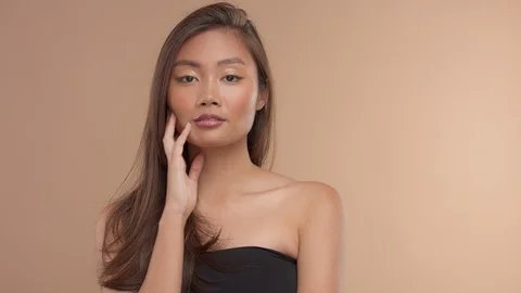 Thai asian model with natural makeup on beige background Stock Footage 99298641