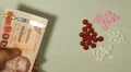 Thai Baht THB, Counting Drugs and Money, Health Care, Colorful Pills HD Footage