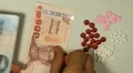 Thai Baht THB, Counting Drugs and Money, Health Care, Colorful Pills HD Footage