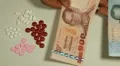 Thai Baht THB, Counting Drugs and Money, Health Care, Colorful Pills HD Footage