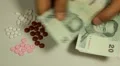 Thai Baht THB, Counting Drugs and Money, Health Care, Colorful Pills HD Footage