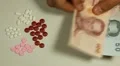 Thai Baht THB, Counting Drugs and Money, Health Care, Colorful Pills HD Footage