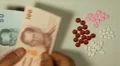 Thai Baht THB, Counting Drugs and Money, Health Care, Colorful Pills HD Footage
