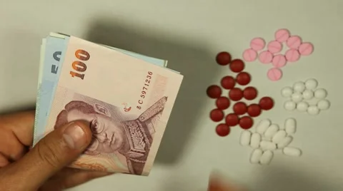 Thai Baht THB, Counting Drugs and Money, Health Care, Colorful Pills Stock Footage
