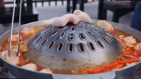 Thai BBQ Hot Pot with Dome Grill Simmering in Spicy Broth, Close-Up Видео 333296570