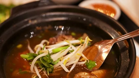 Thai Beef Noodle Soup in Clay Pot with Bean Sprouts Stock Footage 345463912