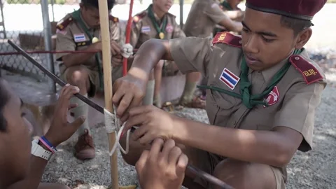 Thai Boy Scout activities students in uniform learn to join sticks tie with rope Stock Footage 157442323