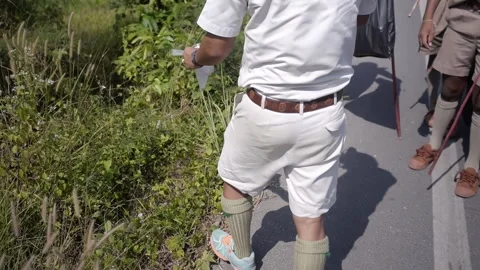 Thai Boy Scout activities teacher in uniform pick up and collect trash Stock Footage 157441776