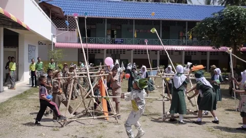 Thai Boy Scout battle activity happy boys and girls play wooden catapult Stock Footage 157281735