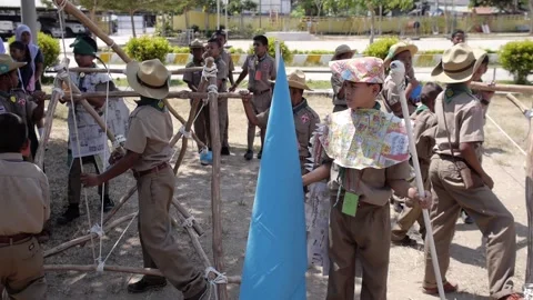 Thai Boy Scout battle activity boys and girls team ready to play wooden catapult Stock Footage 157281855