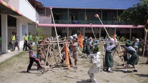 Thai Boy Scout camp activity happy boys and girls play wooden catapult joy fun Stock Footage 157282055