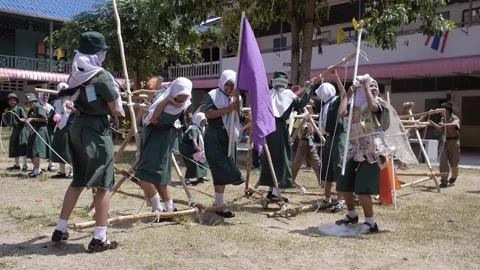 Thai Boy Scout camp activity happy girls play wooden catapult, joy and fun Stock Footage 157282194