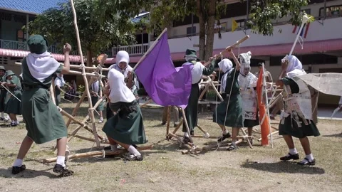 Thai Boy Scout camp activity happy girls play wooden catapult, joy and fun Stock Footage 157282310