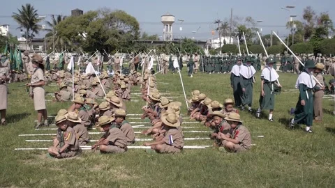 Thai Boy Scout children preparing to parade, tired boys and girls in uniform Stock Footage 157699214