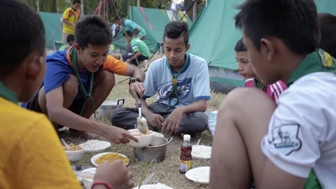 Thai Boy Scout together cooking rice and noodles share food from pot Stock Footage 157441005