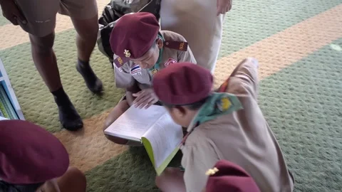 Thai Boy Scout in uniform reading book together secondary school students Stock Footage 157441752