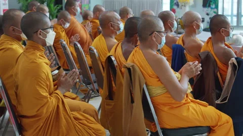 Thai Buddhist Monks Sit &amp; Pray In Orange Robe, Wear Face Mask, Indoor Ceremony Stock-Footage 247668422