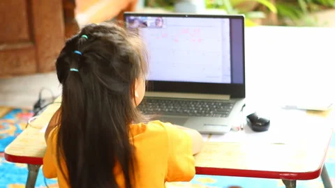 Thai child open her face on  laptop  ,indoor  Chiangmai  Thailand. Stock Footage 157671740