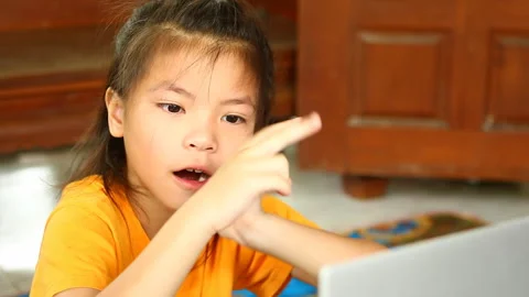 Thai child yawning  while learning online by laptop  ,indoor  Chiangmai  Thailan Stock Footage 157671715