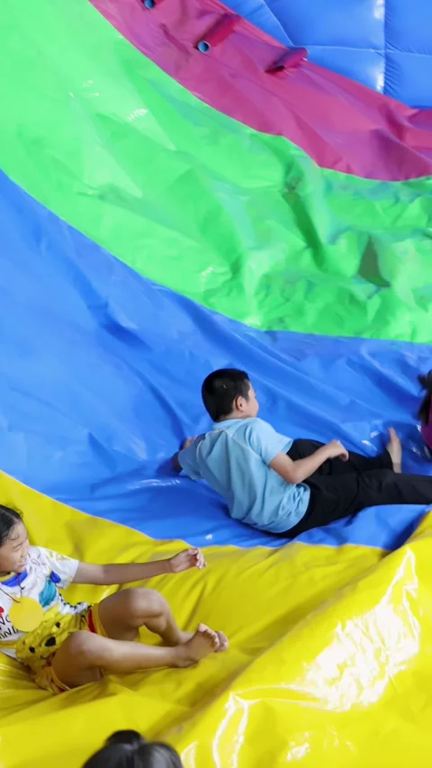 Thai Children Having Fun Sliding Down Large Colorful Inflatable Slide Stock Footage 328281129