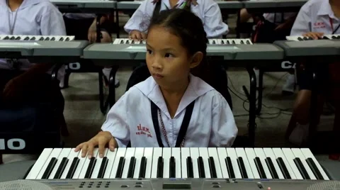 Thai Children study piano in classroom Stock Footage 46837225