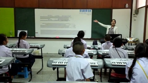 Thai Children study piano in classroom Stock Footage 46837566