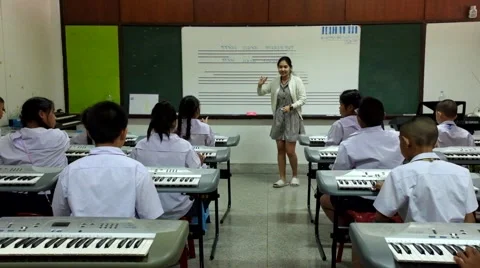 Thai Children study piano in classroom Stock Footage 46838405