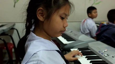 Thai Children study piano in classroom Stock Footage 46840899
