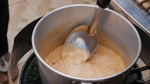 Thai chili paste is added to boiling coconut milk. Step by step cooking tom yam Stock Footage 106425237