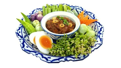 Thai chili paste dip with boiled egg and fresh vegetables on white background. Stock Photos