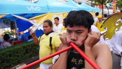 Thai Chinese Man with Axe in Cheeks on Parade on Vegetarian Festival Stock Footage 71007041