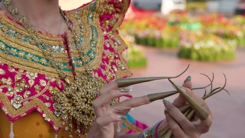 Thai Classical Dancer Putting on Traditional Long Fingernail Extensions Stock Footage 337388625