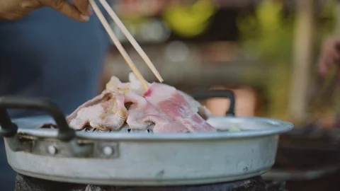 Thai common buffet, grill pork or barbecue on hot pan Stock Footage 117290893