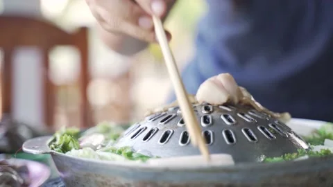 Thai common buffet, grill pork or barbecue on hot pan Video stock 165680797